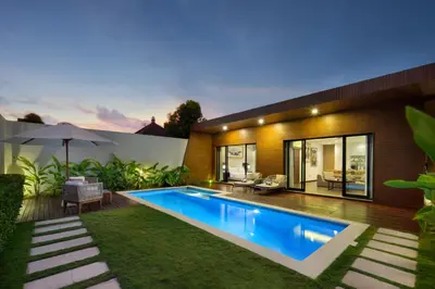 a swimming pool in the backyard of a house at The Claremont Luxury Villas in Seminyak