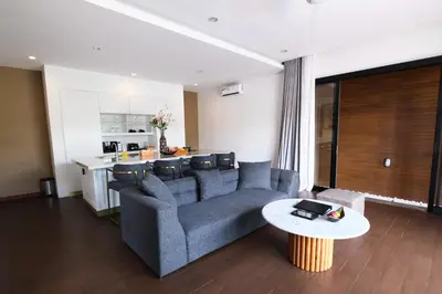 a living room with a couch and a table at The Claremont Luxury Villas in Seminyak