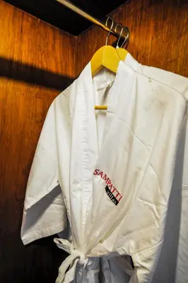a white shirt is hanging on a hanger at Sampatti Villas in Seminyak