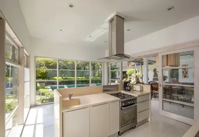 a kitchen with white cabinets and a stove top oven at 2BR Private Villa Seminyak, Villa Kiran One in Seminyak