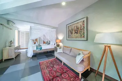 a living room with a couch and a bedroom at Villa Litera Canggu Bali in Canggu