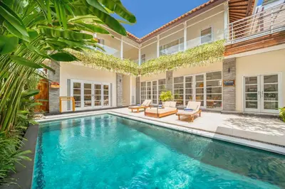 a swimming pool in the backyard of a home with a house at Villa Milano - Private 6 BDR Villa in Seminyak, prime Location, Pool & Garden in Canggu