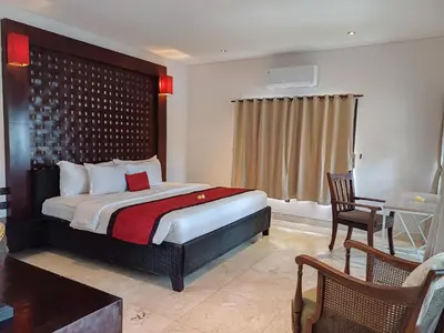 a bedroom with a bed and a desk and a chair at Harmony Villa Dua in Seminyak