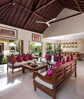 a living room with couches and a table at Villa Songket in Kerobokan