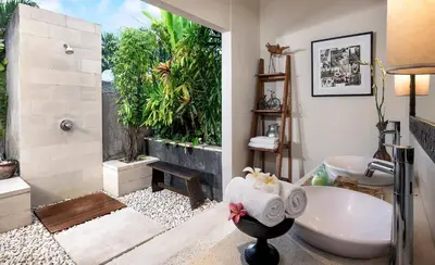 a bathroom with a shower and a toilet and a sink at Villa Songket in Kerobokan