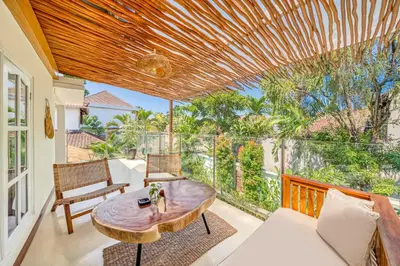 a living room with a table and chairs on a balcony at Villa Florence - 3BDR Luxury Villa, Private Pool, Walk to the Beach in Seminyak