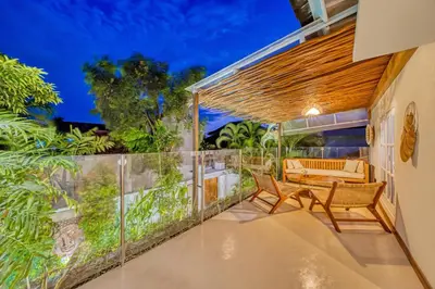 an outdoor patio with two chairs and a table at Villa Florence - 3BDR Luxury Villa, Private Pool, Walk to the Beach in Seminyak