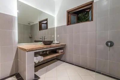 a bathroom with a sink and a mirror at Bunga 2 in Seminyak