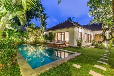 an exterior view of a villa with a swimming pool at Bunga 2 in Seminyak
