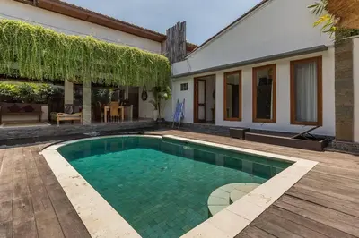 a swimming pool in the yard of a house at Pulesari 3 bedrooms in Seminyak