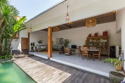 a house with a swimming pool and a dining room at Pulesari 2 bedrooms in Seminyak