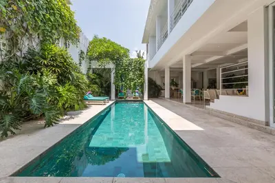 a swimming pool in the middle of a building at Villa Lansel in Seminyak
