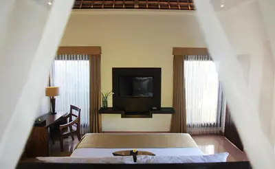 a bedroom with a bed and a tv on the wall at The Haere Seminyak - By Astadala in Seminyak