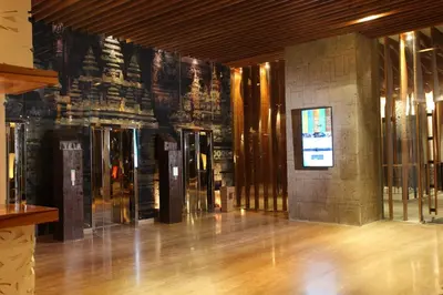 a lobby of a building with a sign on the wall at TS SUITES Seminyak Bali in Legian