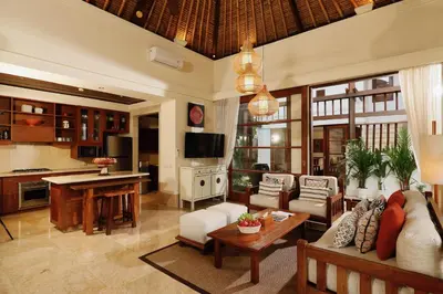 a living room with a couch and a table at Jimbaran Beach Villas by Nakula in Jimbaran