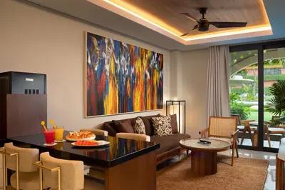 a living room with a large painting on the wall at Beachwalk Residence in Kuta