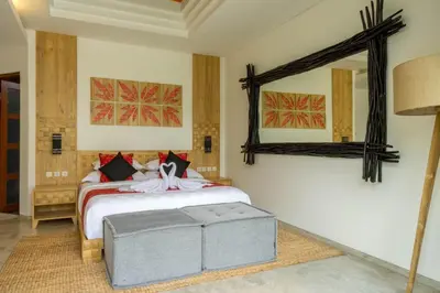 a bedroom with a bed and a large mirror at Cascata Villa Canggu in Canggu