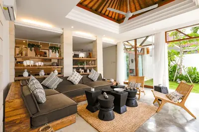 a living room with a couch and chairs at Cascata Villa Canggu in Canggu