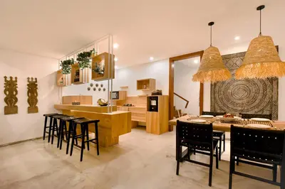 a kitchen and dining room with a table and chairs at Cascata Villa Canggu in Canggu