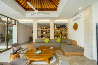 a living room with a couch and a table at Cascata Villa Canggu in Canggu