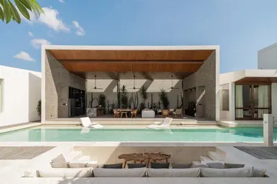 a villa with a swimming pool and a house at Villa Boya - 6BR luxury oasis in Central Berawa in Canggu
