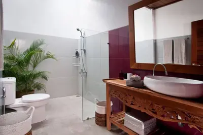 a bathroom with a sink and a toilet and a mirror at 2BR Villa Violetta - Minggu Villas - Special Stay Bonus in Kerobokan