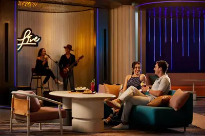 a group of people sitting in a living room with a band at Aloft Bali Kuta at Beachwalk in Kuta