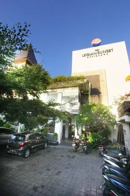 a building with a car parked in a parking lot at The Legian Sunset Residence in Seminyak