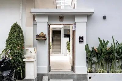 a white house with an open door at The Eight Villa & Rooms Bali - Seminyak in Seminyak