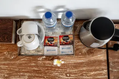 a tray with two bottles of water and a cup at The Eight Villa & Rooms Bali - Seminyak in Seminyak