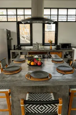 a kitchen with a table with plates on it at Villa Sakayana 4BR Canggu in Canggu