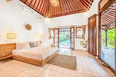 a bedroom with a large bed in a room at Villa Toscana - 7 BDR Luxury Villa with private pool in Seminyak
