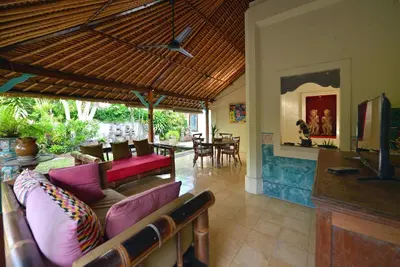 a living room with a couch and a table at Bebek Cottages Sanur in Sanur