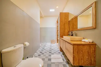 a bathroom with a toilet and a sink and a mirror at Villa Paradise Seminyak in Seminyak