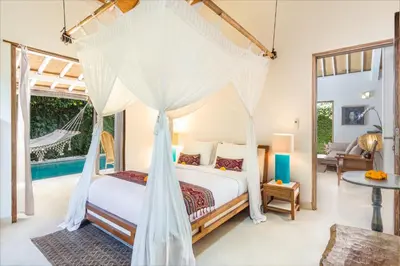 a bedroom with a canopy bed in a villa at Villa 007 in Seminyak