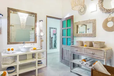 a bathroom with a sink and a mirror at Villa 007 in Seminyak
