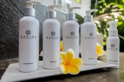 a group of white bottles on a counter with a flower at Villa 007 in Seminyak