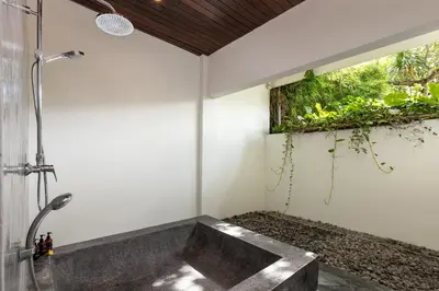 a bathroom with a shower and a sink at Andaman Umalas by Kerta Living in Canggu