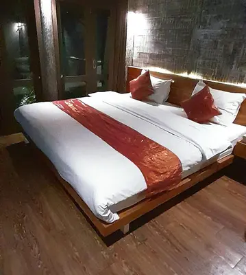 a large bed with white sheets and red pillows at PROMO Private Vacation Rental Villa 2 Pools 4 Bedrooms 4 Bathrooms Free Scooter up to 3 scooters in Seminyak
