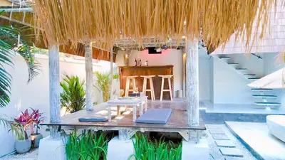 a room with a table and a bar and stairs at PROMO Private Vacation Rental Villa 2 Pools 4 Bedrooms 4 Bathrooms Free Scooter up to 3 scooters in Seminyak
