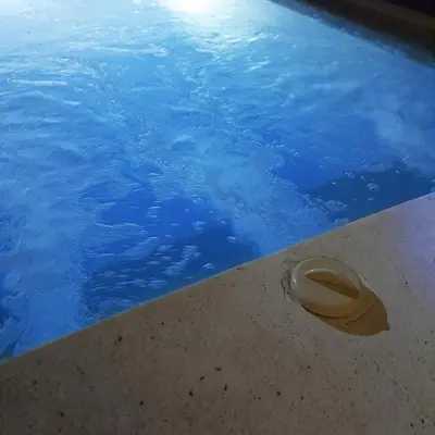 a hat sitting on the edge of a swimming pool at PROMO Private Vacation Rental Villa 2 Pools 4 Bedrooms 4 Bathrooms Free Scooter up to 3 scooters in Seminyak