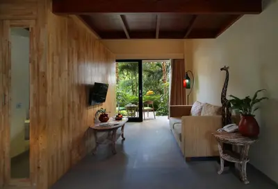 a living room with a couch and a table at Pandawa All Suites Hotel in Seminyak