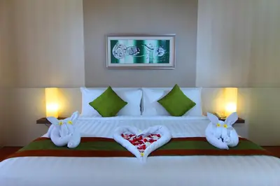 a bedroom with a bed with two rabbits with hearts on it at Papillon Umalas Villas in Canggu