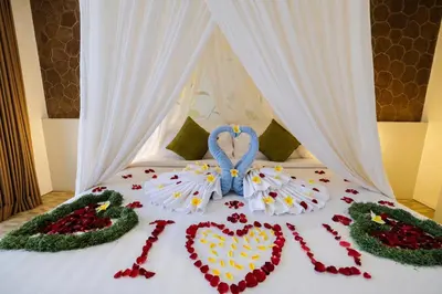 a bed with a heart made out of flowers at Papillon Umalas Villas in Canggu