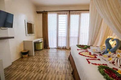 a bedroom with a bed with flowers and swans on it at Papillon Umalas Villas in Canggu