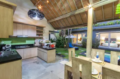 an open kitchen with a view of a backyard at Villa Jalak in Seminyak