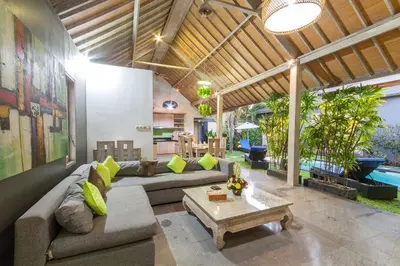 a living room with a couch and a table at Villa Jalak in Seminyak