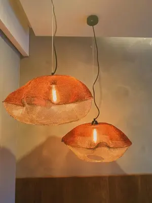 three light fixtures hanging from a ceiling at Tekuni 2 in Legian