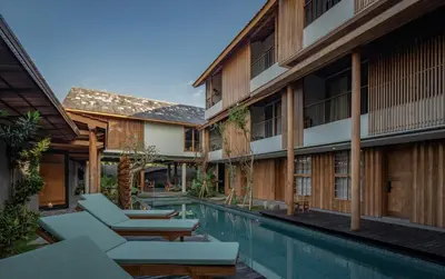 an exterior view of a resort with a swimming pool at Tekuni 2 in Legian