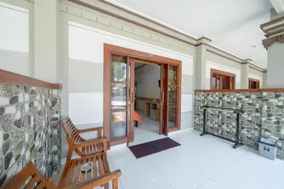 a room with a bench and a stone wall at Bendesa Accommodation in Kuta